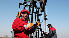 Man reviewing document at oil drilling platfomr
